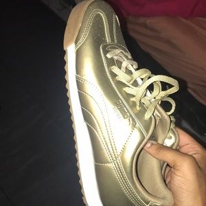 Gold puma shoes